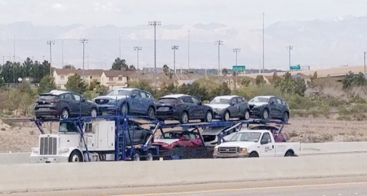 Car carrier loaded with SUVs ready for delivery